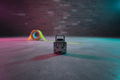Open road-case latch on concrete warehouse floor with magenta-cyan stage lighting